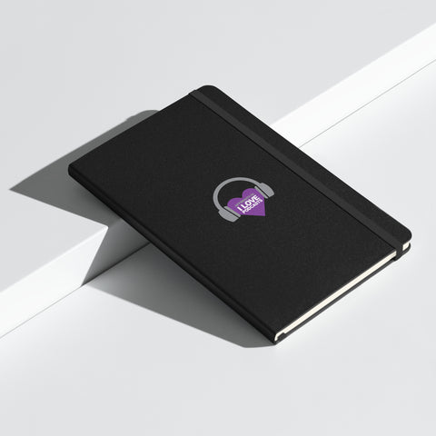 Image of A black "Boss Uncaged: Unleashing Ideas - I Love Podcasting" hardcover notebook with a purple heart on it from the Boss Uncaged Store.