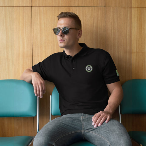 Image of A man sitting in a chair wearing sunglasses and a Boss Uncaged Men's Premium Polo from Boss Uncaged Store.