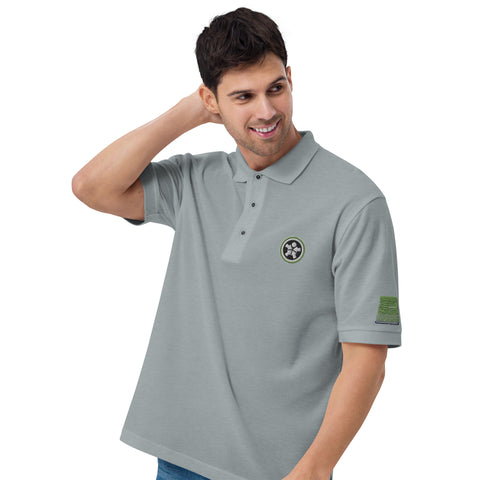 Image of A man wearing a Boss Uncaged Men's Premium Polo shirt with a green patch from the Boss Uncaged Store.