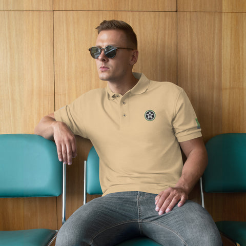 Image of A man wearing sunglasses and a Boss Uncaged Men's Premium Polo shirt sitting on a bench.