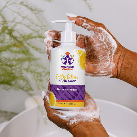 Image of A woman is washing her hands with the Uncaged Foodies - Zesty Citrus Refreshing hand & body wash from Boss Uncaged Store.