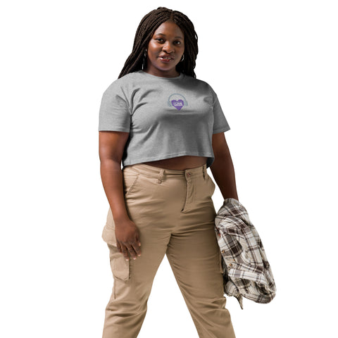 A woman sporting a trendy Boss Uncaged Store Affirmation I Love Podcasts - Women’s crop top paired with khaki pants.
