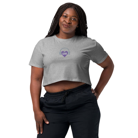A woman wearing the Boss Uncaged Store Affirmation I Love Podcasts - Women’s crop top with a purple heart on it.