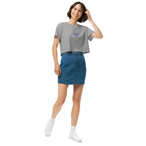 A woman wearing an Affirmation I Love Podcasts crop top from the Boss Uncaged Store and blue denim skirt.