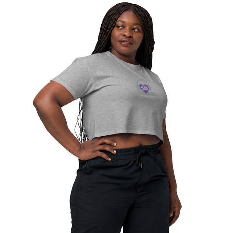 A woman confidently dons an Affirmation I Love Podcasts - Women's crop top from Boss Uncaged Store, written in bold letters, paired effortlessly with black pants.