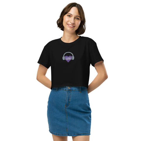 A woman wearing an Affirmation I Love Podcasts - Women’s crop top from the Boss Uncaged Store, with a purple heart on it, featuring the keyword "Boss Uncaged".