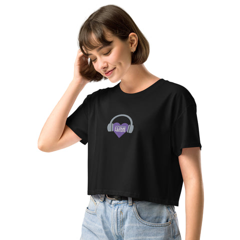 A Boss Uncaged Store fan sporting an Affirmation I Love Podcasts women's crop top with a purple heart on it.