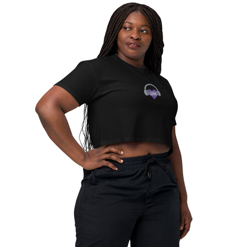 A woman wearing an Affirmation I Love Podcasts crop top from Boss Uncaged Store with a purple logo.