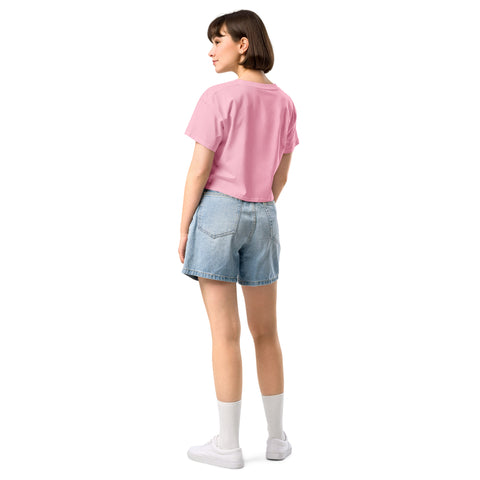 The back view of a woman wearing a pink t-shirt and denim shorts, radiating confidence as she proudly displays her Affirmation I Love Podcasts - Boss Uncaged Store women's crop top.