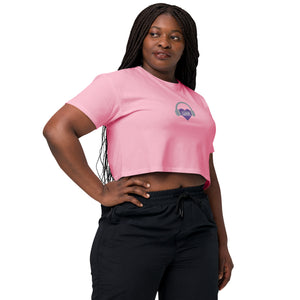 A woman wearing a pink cropped t-shirt and black pants showcases the Boss Uncaged Store's Affirmation I Love Podcasts - Women’s crop top, radiating empowerment and affirmation.