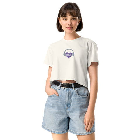 A woman wearing a white cropped t-shirt with a purple heart on it while graciously representing the Affirmation I Love Podcasts - Women’s crop top by Boss Uncaged Store.