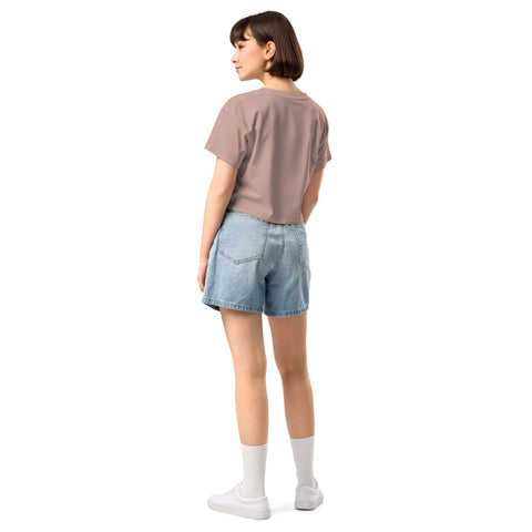 The back view of a woman wearing denim shorts and a brown t-shirt while hosting the Boss Uncaged podcast, wearing the Affirmation I Love Podcasts - Women's crop top from the Boss Uncaged Store.