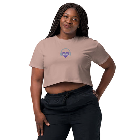 A woman wearing an Affirmation I Love Podcasts - Women’s crop top from Boss Uncaged Store and black pants.