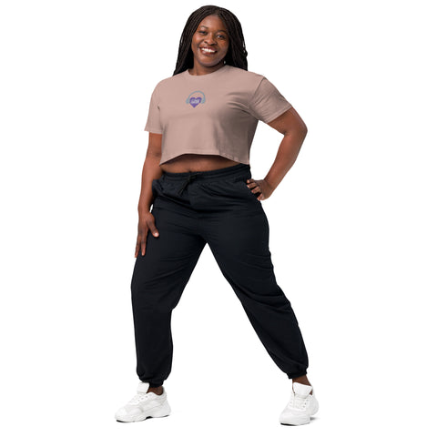 A woman wearing an Affirmation I Love Podcasts - Women's Crop Top from the Boss Uncaged Store and black joggers.