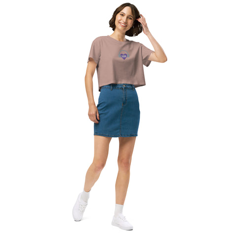 A woman confidently sporting an Affirmation I Love Podcasts - Women's crop top from Boss Uncaged Store and blue denim skirt.