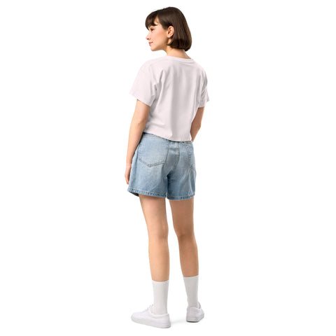 The back view of a woman wearing a white t-shirt and denim shorts, rocking the Affirmation I Love Podcasts - Women’s crop top from Boss Uncaged Store.