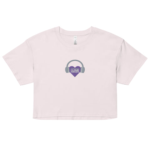 A stylish Boss Uncaged Store women's crop top featuring the Affirmation I Love Podcasts design with a purple heart and headphones.