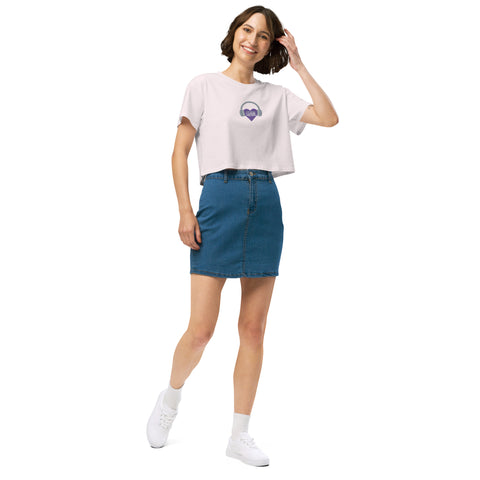 A woman wearing a denim skirt and white Boss Uncaged Store Affirmation I Love Podcasts - Women's crop top.