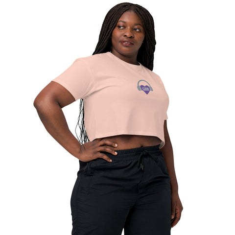 A stylish and empowering woman wearing the Affirmation I Love Podcasts - Women's crop top from Boss Uncaged Store, along with sleek black pants.