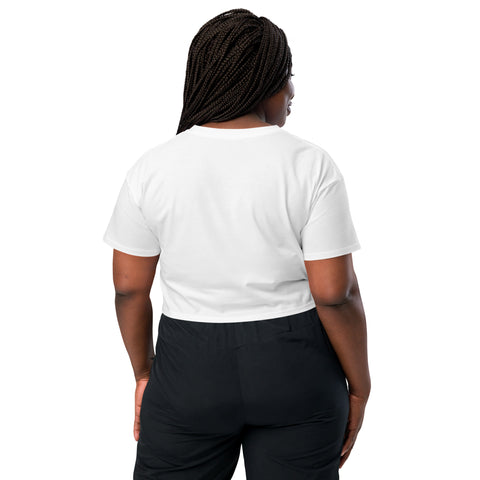 The back view of a woman wearing an Affirmation I Love Podcasts crop top from the Boss Uncaged Store and black pants as she listens to the affirming Boss Uncaged podcast.