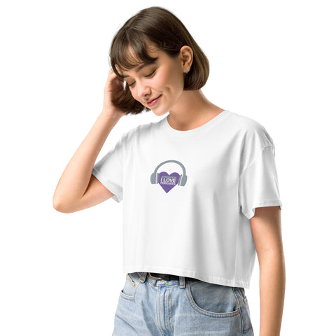 A woman wearing an Affirmation I Love Podcasts - Women's crop top from the Boss Uncaged Store, confidently representing the Boss Uncaged podcast.