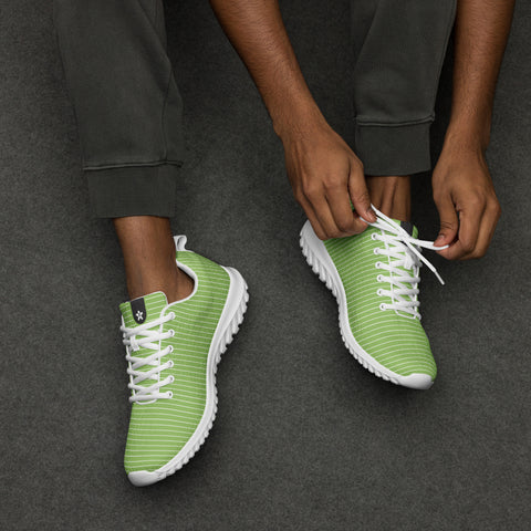 Image of A man is tying a pair of Boss Uncaged Workflow Athletic Shoes (Green) from the Boss Uncaged Store.