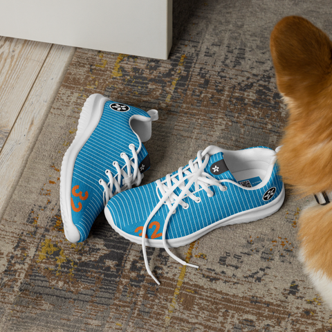 Image of A dog wearing a pair of Boss Uncaged Workflow Athletic Shoes (Blue) next to a door.