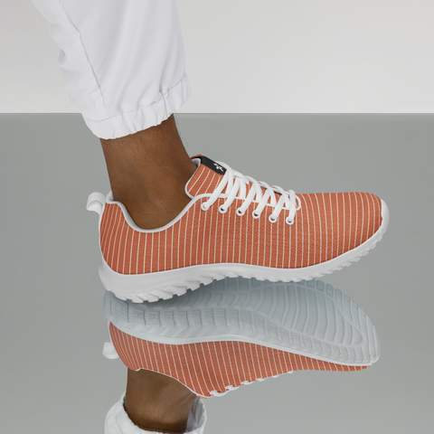 Image of A woman wearing Boss Uncaged Workflow Athletic Shoes (Orange) from the Boss Uncaged Store on a reflective surface.