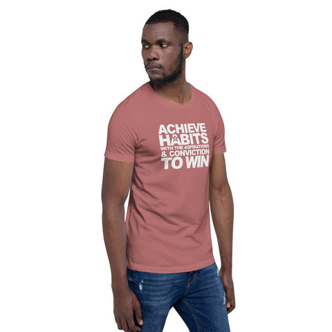 Image of A man wearing a pink t-shirt that says "ACHIEVE HABITS WITH THE ASPIRATIONS AND CONVICTION TO WIN." from Boss Uncaged Store.
