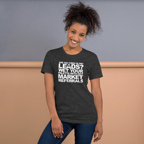 Image of A person smiles, wearing a dark t-shirt from Buteke with the text: "ARE YOU TIRED OF DRY LEADS? WET YOUR PALETTE WITH HOT MARKET REFERRALS," promoting effective networking and connection-building.