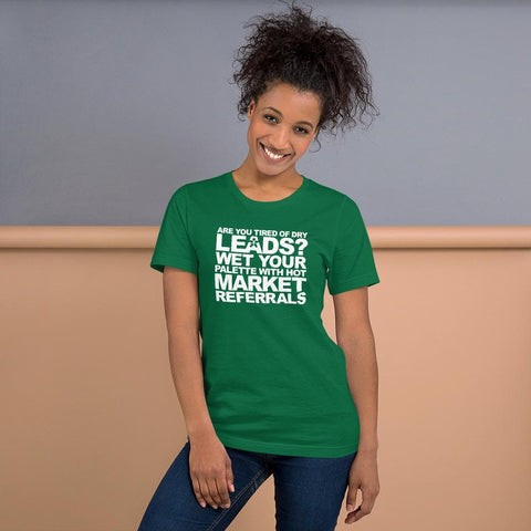 Image of A person stands smiling, wearing a green shirt with white text that says, "ARE YOU TIRED OF DRY LEADS? WET YOUR PALETTE WITH HOT MARKET REFERRALS." by Buteke.