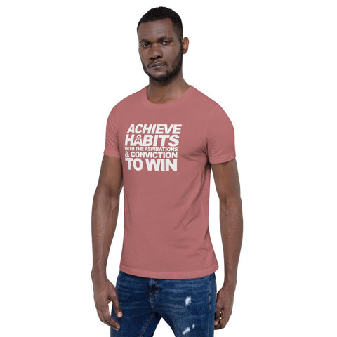 Image of A man wearing a pink t-shirt that says "ACHIEVE HABITS WITH THE ASPIRATIONS AND CONVICTION TO WIN" from Boss Uncaged Store.