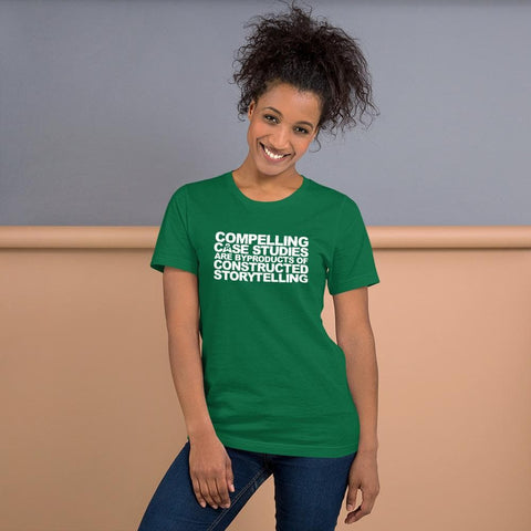 Image of Person wearing a green T-shirt from Buteke, with white text saying, "Compelling case studies are byproducts of constructed storytelling," standing and smiling against a neutral backdrop, embodying the essence of data-driven storytelling.