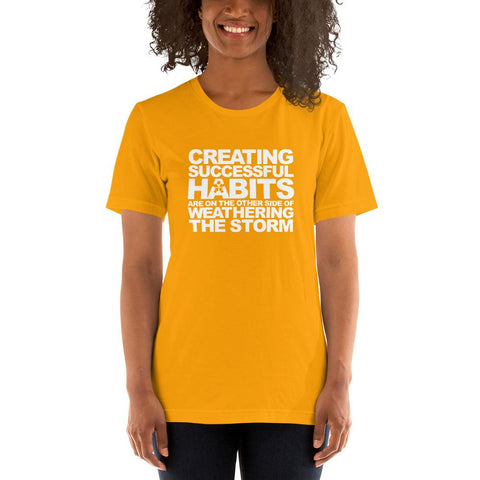 Image of A woman wearing a yellow t-shirt that says "CREATING SUCCESSFUL HABITS ARE ON THE OTHER SIDE OF WEATHERING THE STORM" from Boss Uncaged Store.