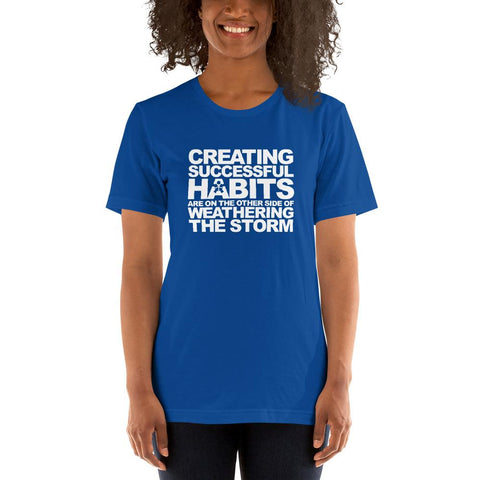 Image of A woman wearing a blue t-shirt from Boss Uncaged Store that says "CREATING SUCCESSFUL HABITS ARE ON THE OTHER SIDE OF WEATHERING THE STORM.