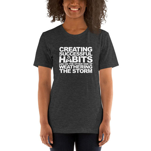 Image of A woman wearing a t-shirt from Boss Uncaged Store that says "CREATING SUCCESSFUL HABITS ARE ON THE OTHER SIDE OF WEATHERING THE STORM.