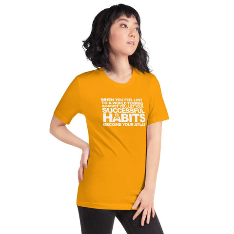 Image of A woman wearing an orange t-shirt with the words, "WHEN YOU FEEL LOST TO A WORLD TURNING AGAINST YOU, LET YOUR SUCCESSFUL HABITS BECOME YOUR ATLAS." from Boss Uncaged Store.