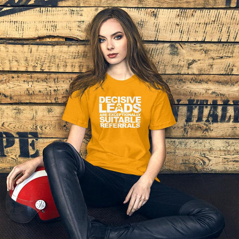 Image of A woman in a yellow Buteke t-shirt with the printed message "DECISIVE LEADS ARE AN EXCEPTIONALLY SUITABLE REFERRAL" sits on the floor against a wooden wall, contemplating her next strategy.