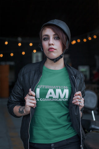 Image of A woman wearing a green t-shirt that says "AFFIRMATION: I AM A COMMUNICATOR" from Boss Uncaged Store.