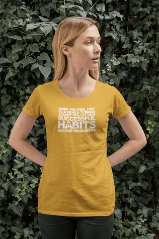 Image of A woman wearing a yellow t-shirt with the words "WHEN YOU FEEL LOST TO A WORLD TURNING AGAINST YOU, LET YOUR SUCCESSFUL HABITS BECOME YOUR ATLAS." from Boss Uncaged Store.