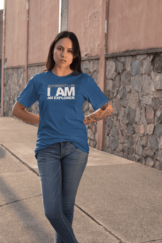 Image of A woman wearing a blue t - shirt with the affirmation "I AM AN EXPLORER" from Boss Uncaged Store and jeans.