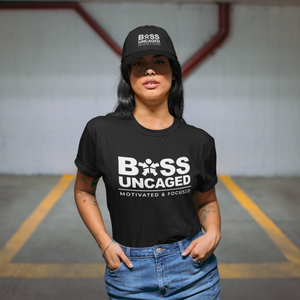 A woman wearing a black t-shirt that says "Boss Uncaged Motivated and Focused" from the Boss Uncaged Store.